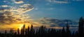 Landscape with dramatic light - beautiful golden sunset with saturated sky and clouds. Royalty Free Stock Photo