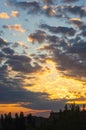 Landscape with dramatic light - beautiful golden sunset with saturated sky and clouds. Royalty Free Stock Photo