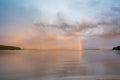 Landscape with dramatic sky, rainy clouds and rainbow. Royalty Free Stock Photo