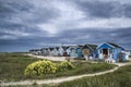 Beautiful landscape of dramatic stormy sky over beach huts in gr Royalty Free Stock Photo