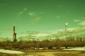 Landscape with a drilling rig at an oil field. Sunny day, early spring. Industrial landscape. Russia, Western Siberia.