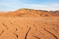 The landscape of dry mountains and mud cracked pattern on desert ground