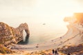 Landscape of Durdle Door with all over the world intarnational turists joining view of Sunset. Dorset, England. Selective focus. C