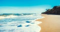 Landscape empty deserted sand beach and sea waves with foam surf with blue sky and white clouds Royalty Free Stock Photo