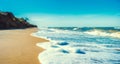 landscape empty deserted sand beach and sea waves with foam surf with blue sky and white clouds Royalty Free Stock Photo