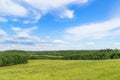 Landscape of European plains with hills and lowlands, marshes, meadows and forests. Cloudy Blue sky over horizon Royalty Free Stock Photo