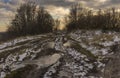 Landscape with extremely dirty road leading to small Ukrainian village Shpilivka in Sumskaya oblast, Ukraine