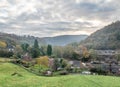 Landscape of a farm surrounded by houses and greenery under a cloudy sky in Ironbridge Royalty Free Stock Photo