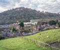 Landscape of a farm surrounded by houses and greenery under a cloudy sky in Ironbridge Royalty Free Stock Photo