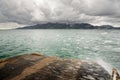 Landscape with ferry ramp, tropical sea, monsoon storm heavy clouds and tropical Koh Chang island on horizon in Thailand Royalty Free Stock Photo