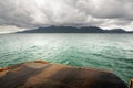 Landscape with ferry ramp, tropical sea, monsoon storm heavy clouds and tropical Koh Chang island on horizon in Thailand Royalty Free Stock Photo