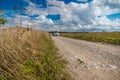 Landscape of a field and a car on a country road, car house, summer day, august, man and woman travel