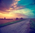 Landscape with Field and Country Road at Sunset Royalty Free Stock Photo