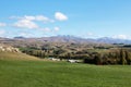 Landscape of fields, mountains and blue sky in autumn on the south island of New Zealand. Royalty Free Stock Photo