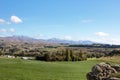 Landscape of fields, mountains and blue sky in autumn on the south island of New Zealand. Royalty Free Stock Photo