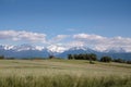 Landscape of fields with snowy mountains behind Royalty Free Stock Photo