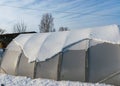 landscape with a film greenhouse snow on the greenhouse winter