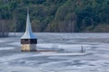 Landscape of a flooded church in toxic polluted lake due to copper mining