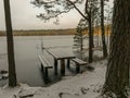 Landscape with flooded lake shore, picnic area covered with ice Royalty Free Stock Photo