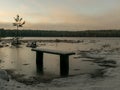 Landscape with flooded lake shore, picnic area covered with ice Royalty Free Stock Photo