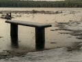 Landscape with flooded lake shore, picnic area covered with ice Royalty Free Stock Photo