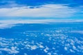 Landscape of fluffy white clouds on a dark blue sky. View from the plane at high altitude Royalty Free Stock Photo