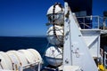 Landscape format image of life-rafts/lifeboats in their containers on ship's deck