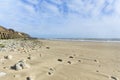 Landscape format wide angle pebble beach and blue sky Royalty Free Stock Photo