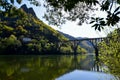 Landscape formed by a river a bridge and a mountain