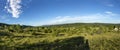 Landscape in the french Jura region with green meadows and blue