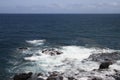 Oceanfront landscape in which waves crash against rocks near the coast of the island Royalty Free Stock Photo