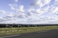 Landscape full of solar panels along a highway with blurred foreground Royalty Free Stock Photo