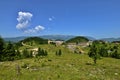 Landscape with the Fundata Resort at Cheile Gradistei with Piatra Craiului Mountains in the background. Royalty Free Stock Photo