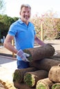 Landscape Gardener Laying Turf For New Lawn