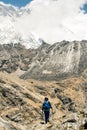 Landscape with girl, high mountains with snowy peaks, path, blue sky in Nepal. Travel. Vintage style. Nature Royalty Free Stock Photo