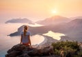 Landscape with girl, sea, mountains and orange sky Royalty Free Stock Photo