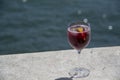 Landscape of glass of sangria on a ledge near water in summer in Lisbon Portugal