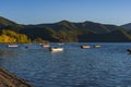 Landscape of gondolas on a lake surrounded by hills on a sunny day