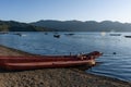 Landscape of gondolas on a lake surrounded by hills on a sunny day