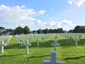 Landscape of a graveyard with white crosses in the green field Royalty Free Stock Photo