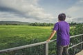 Landscape of green forest with back of asian man tourist traveller in the mountain