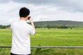Landscape of green forest with back of asian man tourist traveller in the mountain
