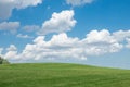 Beautiful landscape. Green grass field and cloudy blue sky Royalty Free Stock Photo