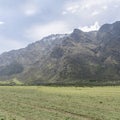 The Remarkables range and green fields, at Kawarau Falls, New Zealand Royalty Free Stock Photo