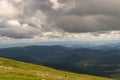 Landscape of green valley flooded with light with lush green grass, mountains, covered with stone and hills, a fresh summer day u Royalty Free Stock Photo