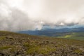 Landscape of green valley flooded with light with lush green grass, mountains, covered with stone and hills, a fresh summer day u Royalty Free Stock Photo