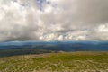 Landscape of green valley flooded with light with lush green grass, mountains, covered with stone and hills, a fresh summer day u Royalty Free Stock Photo