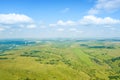 Landscape of green valley flooded with light with lush green grass, mountains, covered with stone and hills, a fresh summer day Royalty Free Stock Photo