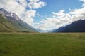 landscape of green yard with mountain with snow on top in sunny day in New Zealand Royalty Free Stock Photo