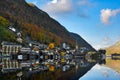 The landscape of Hallstatt, Austria, a riverside village reflecting the calm waters. The shadows in the water look like a mirror